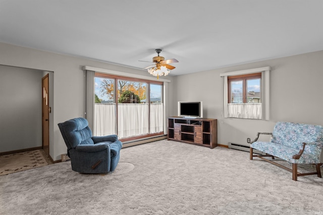 sitting room with a baseboard heating unit, carpet flooring, and ceiling fan