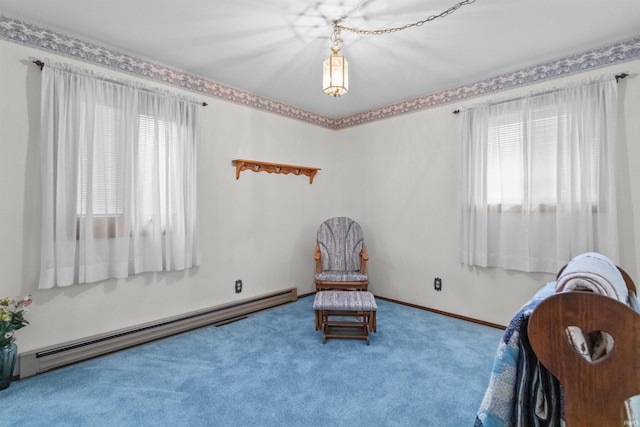 living area featuring baseboard heating and carpet flooring