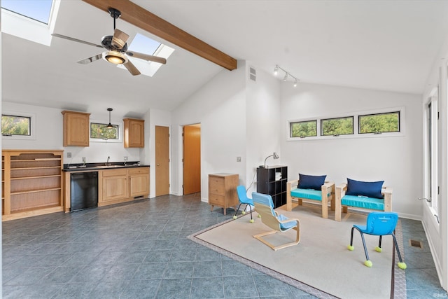 living room with sink, a skylight, ceiling fan, beam ceiling, and high vaulted ceiling