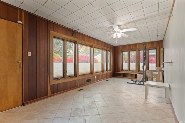 unfurnished sunroom featuring ceiling fan