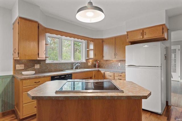 kitchen with black dishwasher, sink, light wood-type flooring, stovetop, and white refrigerator