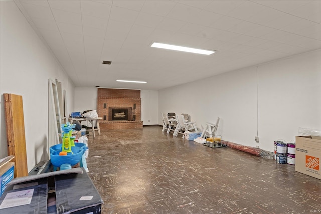 basement featuring a brick fireplace