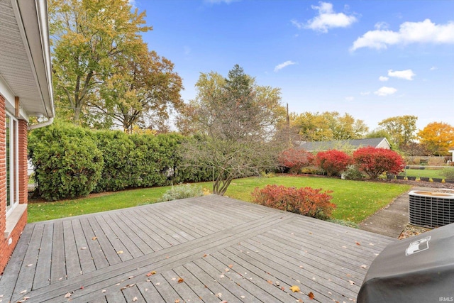 deck with a yard and central AC unit