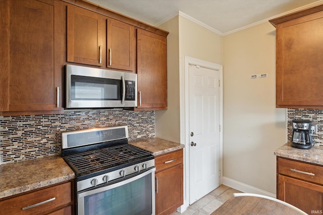 kitchen featuring backsplash, crown molding, light tile patterned flooring, stone counters, and appliances with stainless steel finishes