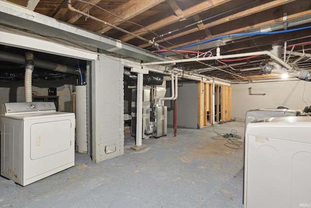 basement featuring water heater and separate washer and dryer