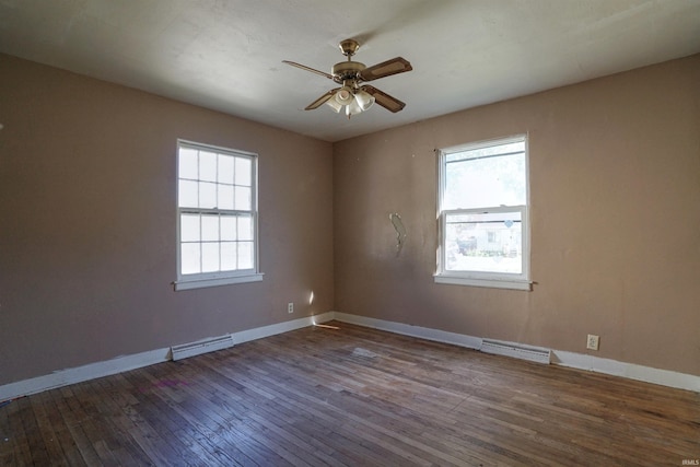 empty room featuring a wealth of natural light, hardwood / wood-style flooring, and ceiling fan