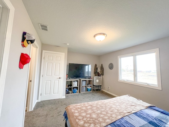 bedroom featuring carpet and a textured ceiling