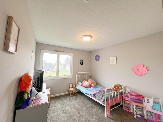 bedroom featuring carpet floors and a textured ceiling