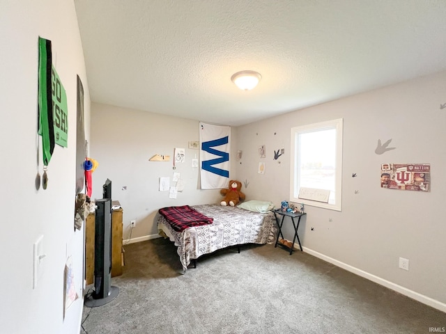 bedroom with carpet and a textured ceiling