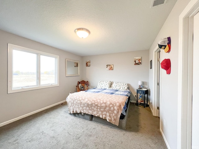 bedroom featuring carpet floors and a textured ceiling