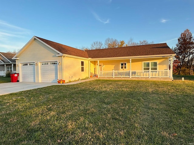 ranch-style house featuring a front yard, covered porch, and a garage