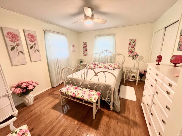 bedroom featuring wood-type flooring, a closet, and ceiling fan