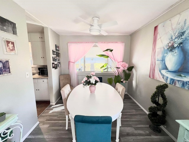 dining area with dark hardwood / wood-style floors and ceiling fan