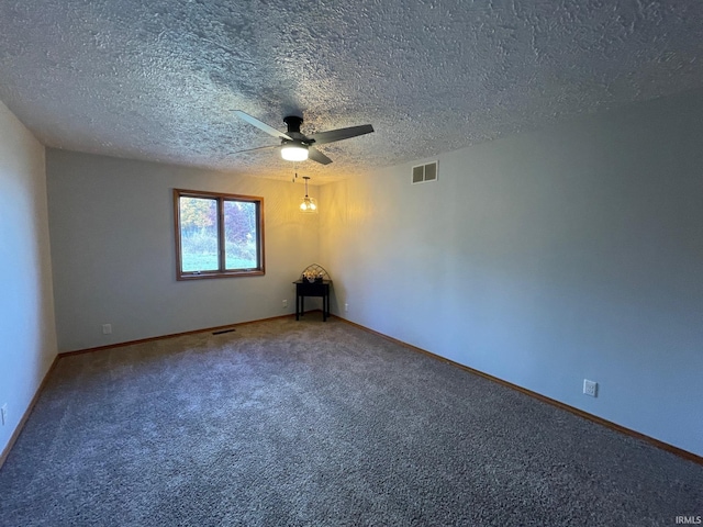 carpeted spare room featuring a textured ceiling and ceiling fan