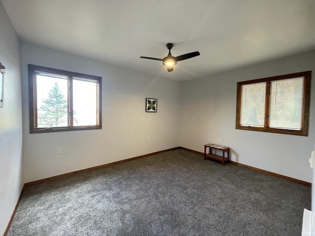 carpeted empty room featuring ceiling fan