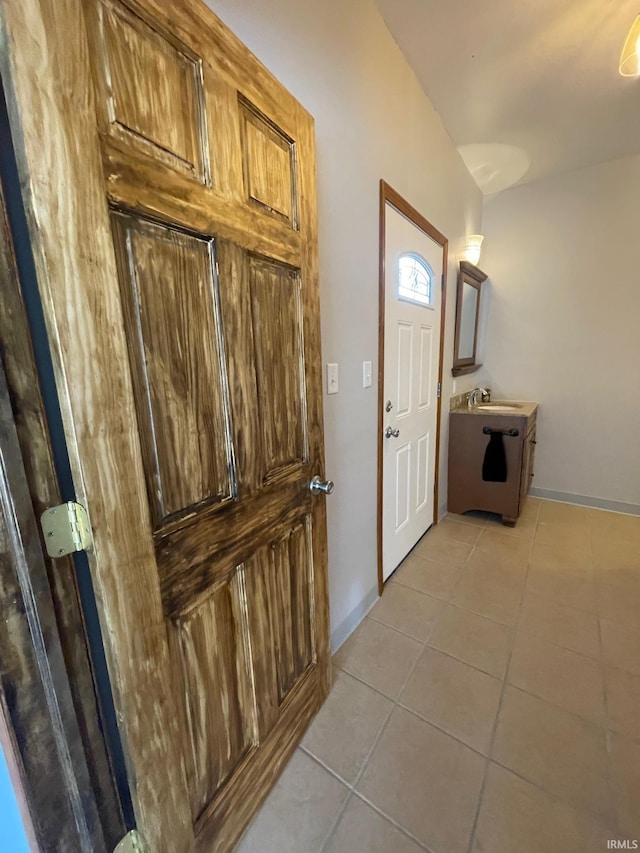 interior space featuring sink and light tile patterned flooring