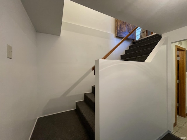 stairway with tile patterned flooring