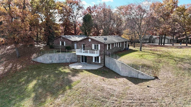 back of property with a patio area and a lawn