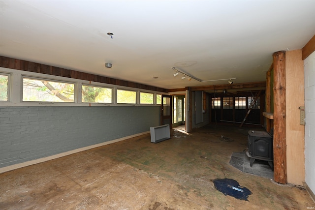 interior space with a wood stove and a wealth of natural light