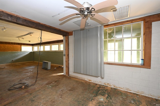 interior space with concrete floors and ceiling fan