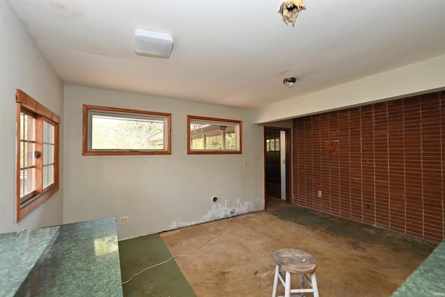 unfurnished room featuring concrete flooring