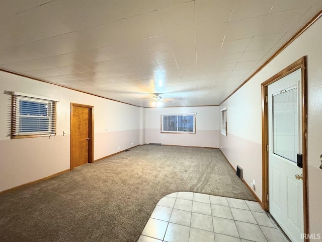 unfurnished room with light carpet, crown molding, and ceiling fan