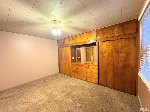 unfurnished bedroom featuring carpet floors and ceiling fan