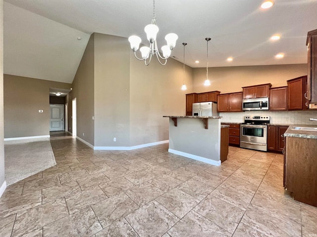 kitchen with hanging light fixtures, a kitchen bar, stainless steel appliances, sink, and a center island