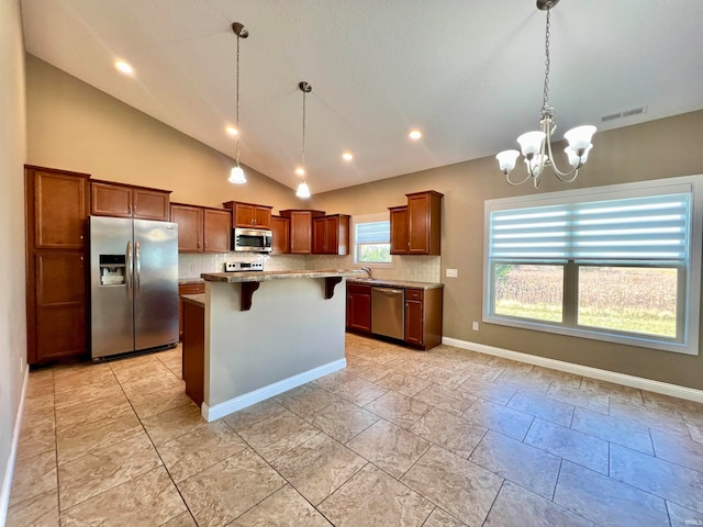 kitchen featuring a center island, stainless steel appliances, vaulted ceiling, decorative backsplash, and a breakfast bar