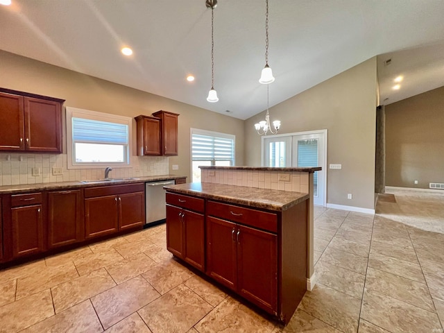 kitchen with dishwasher, decorative backsplash, a kitchen island, pendant lighting, and a chandelier