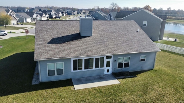 1793 Breckenridge Pass, Fort Wayne, IN 46845 - back of property featuring a lawn, a patio, a shingled roof, and a chimney