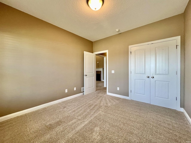 1793 Breckenridge Pass, Fort Wayne, IN 46845 - unfurnished bedroom with a closet, baseboards, carpet flooring, and a textured ceiling