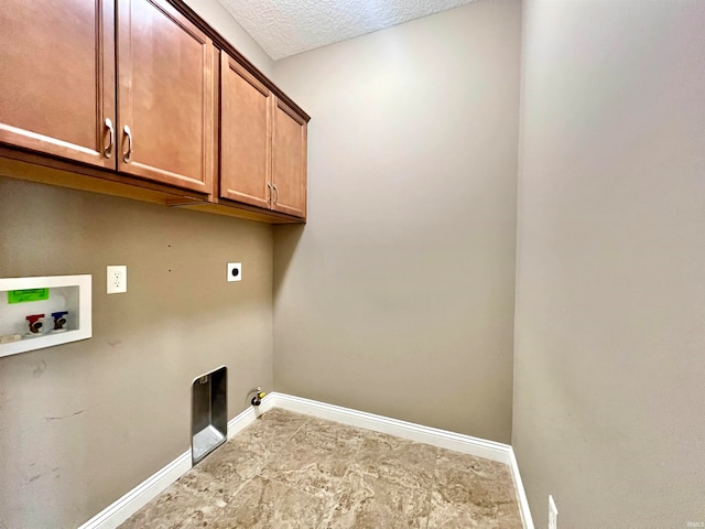 washroom with a textured ceiling, gas dryer hookup, electric dryer hookup, washer hookup, and cabinets