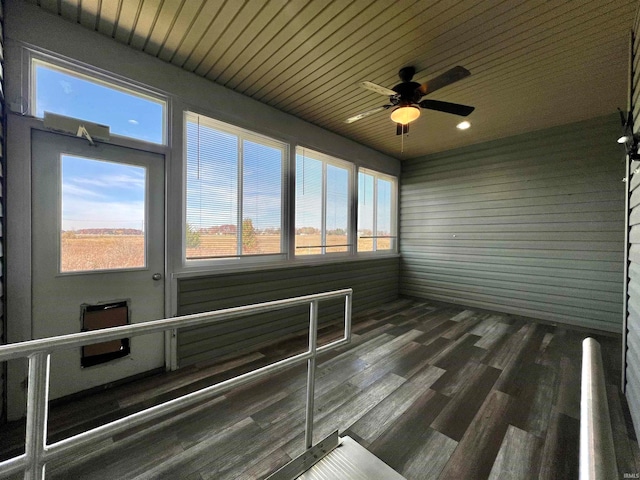 unfurnished sunroom with wood ceiling, plenty of natural light, and ceiling fan