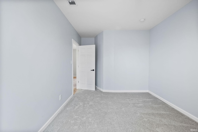 unfurnished room featuring light carpet