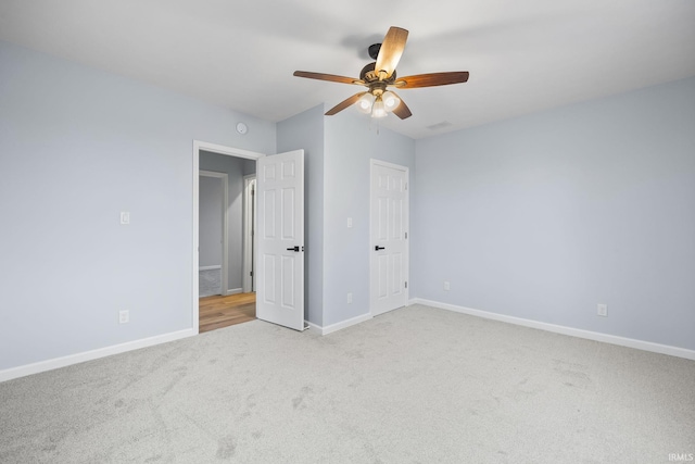 unfurnished bedroom featuring light colored carpet and ceiling fan