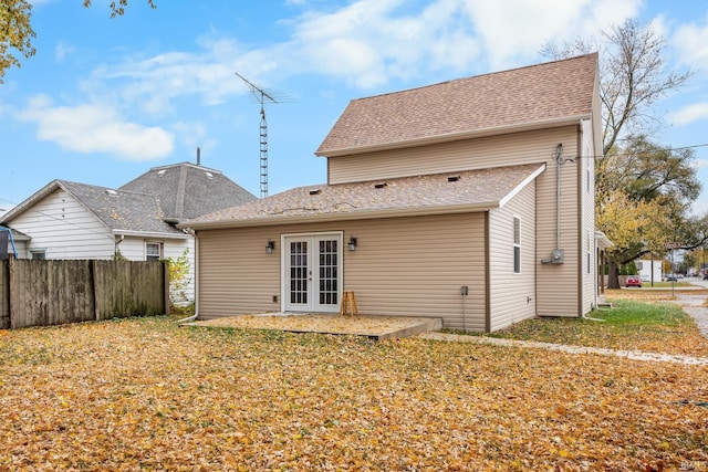 back of property featuring french doors and a yard