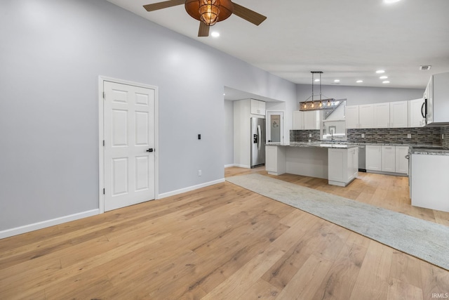 kitchen featuring a kitchen island, white cabinetry, pendant lighting, light hardwood / wood-style flooring, and stainless steel refrigerator with ice dispenser