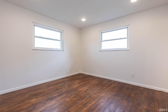 spare room featuring dark wood-type flooring