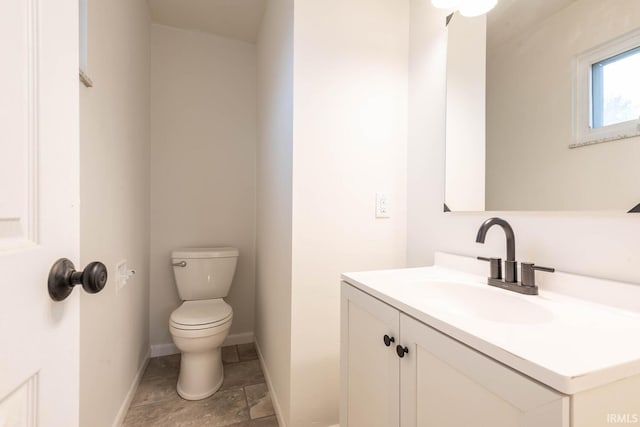 bathroom with toilet and vanity