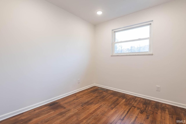 spare room featuring dark hardwood / wood-style floors