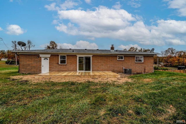 rear view of house featuring central AC, a deck, and a yard