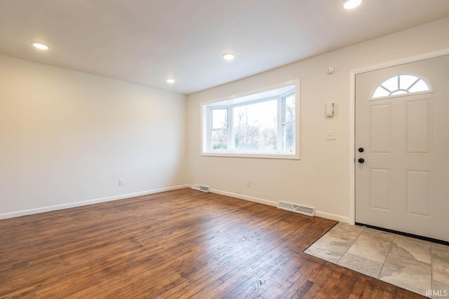 entrance foyer featuring dark hardwood / wood-style floors and plenty of natural light