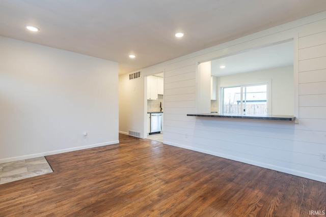 unfurnished living room with wood-type flooring