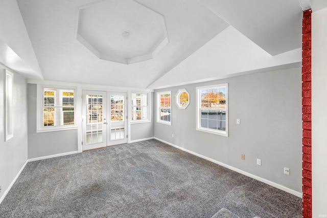 spare room featuring french doors, carpet floors, and a raised ceiling