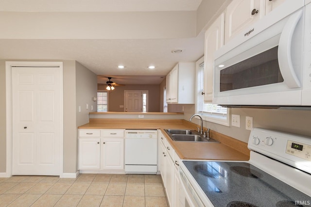 kitchen with sink, light tile patterned flooring, white cabinetry, white appliances, and ceiling fan