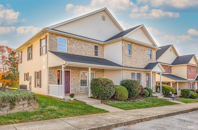 view of front of property featuring a porch, a front lawn, and central AC unit