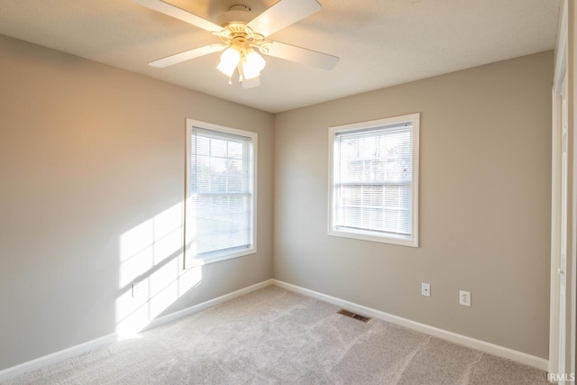 carpeted empty room with ceiling fan