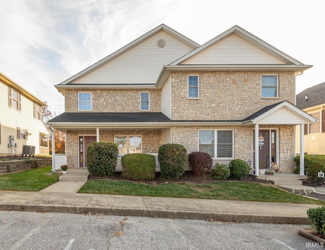 view of front of home with covered porch and central AC