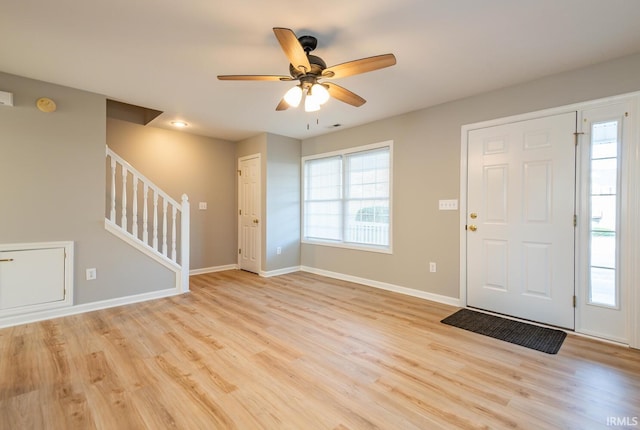 foyer entrance with light hardwood / wood-style floors and ceiling fan